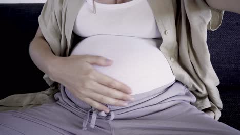 Smiling-pregnant-woman-recording-video-message